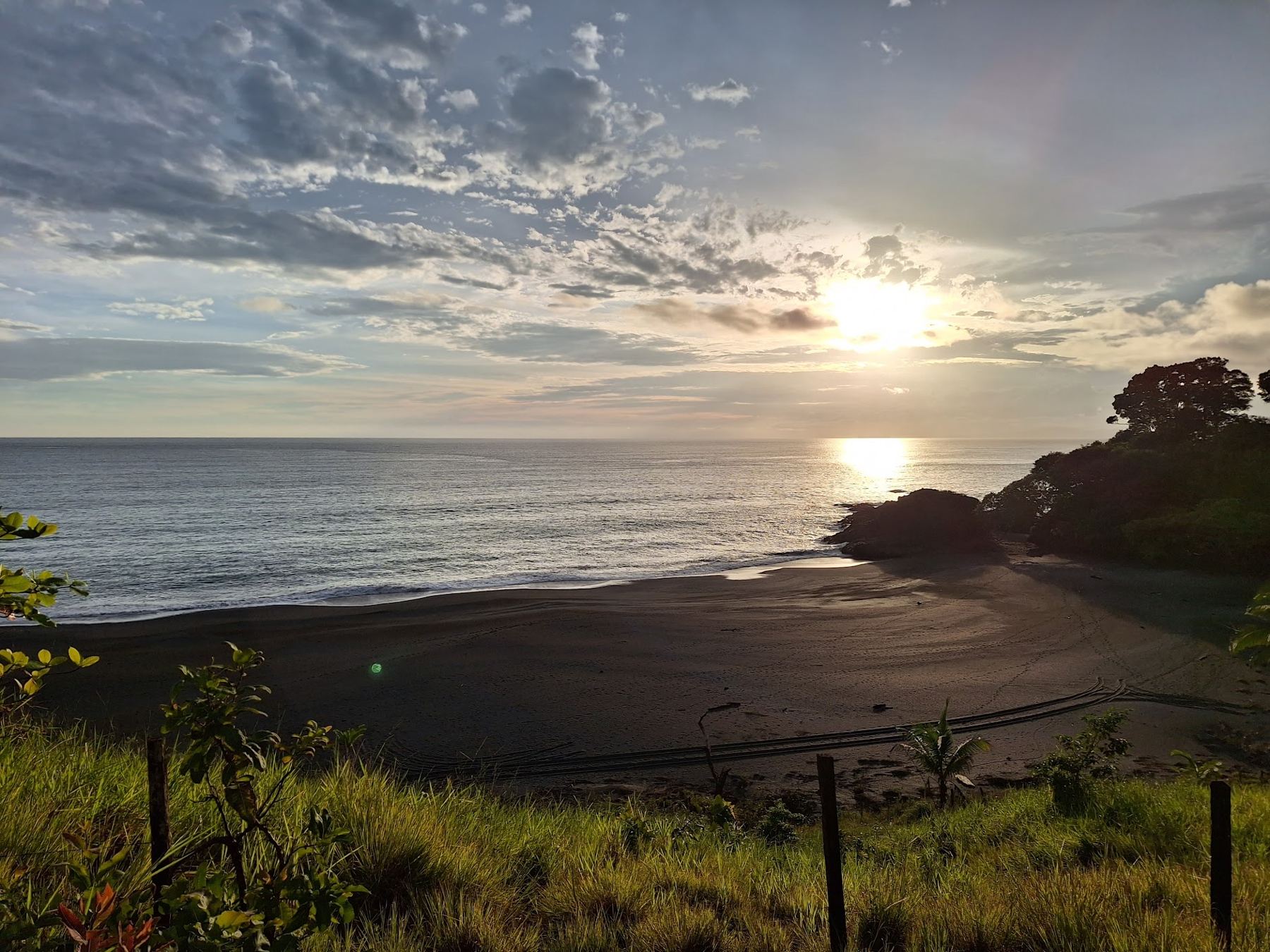 Sunset over the bay below Roca Tortuga, with Turtle Rock and the black-sand beach